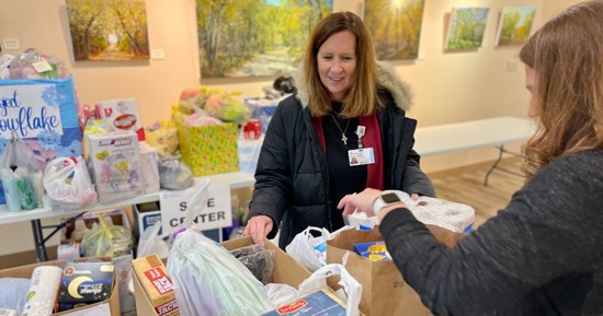 Cindi Richter, Foundation (left) and Anna Fryda, Communication (right) load items donated by Good Samaritan staff onto a cart for the Safe Center. Donated items included diapers, food, clothing and personal hygiene products to help support those affected by domestic violence. 